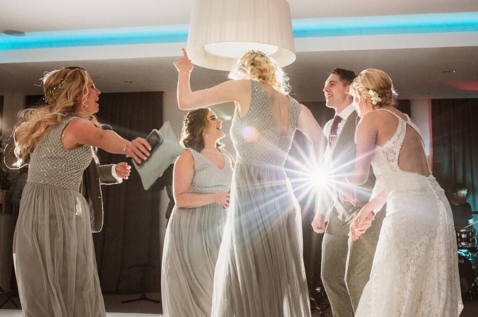 bridesmaids and bride dancing at gorse hill in surrey