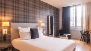 Bed arrangement in Hotel Le Lion of The Originals Hotels