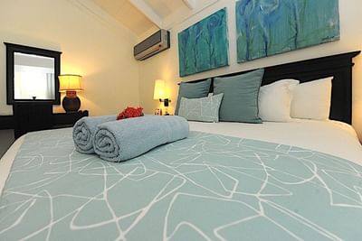 Rolled towels on a bed in Deluxe Room at Blue JackTar Hotel