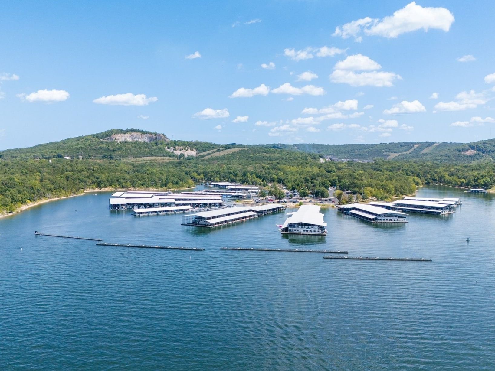 High-angle view of white boat docks on a wide blue lake in Table Rock State Park and Marina near Branson Hillside Hotel