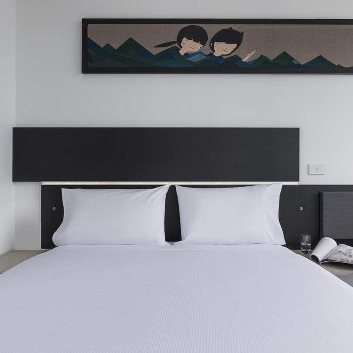 Cozy bed with hanging wall art in Standard Room One Queen Bed at Ibis Adelaide