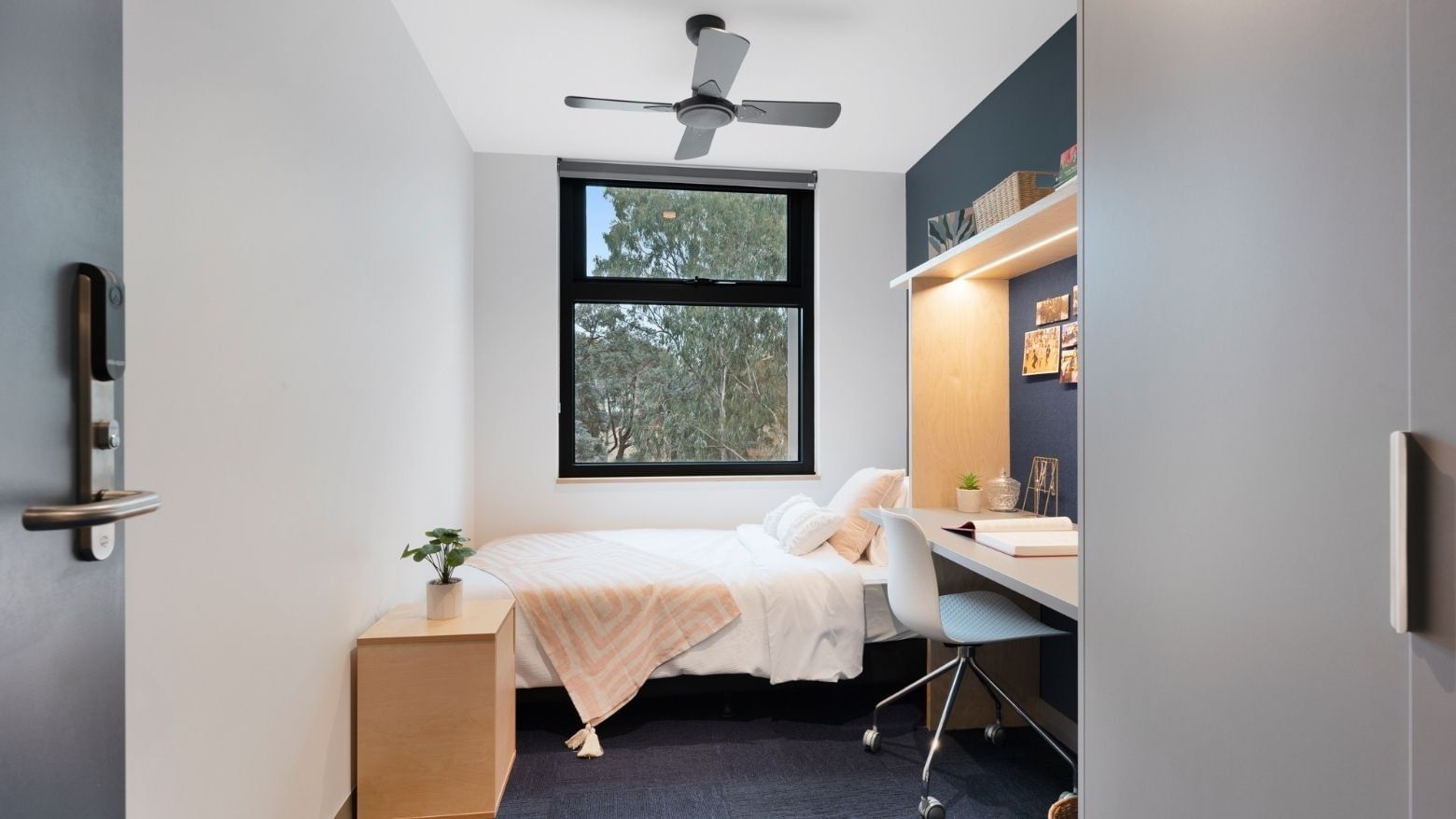 Bedroom with desk, chair, bed, and window at La Trobe University - North and South Apartments.