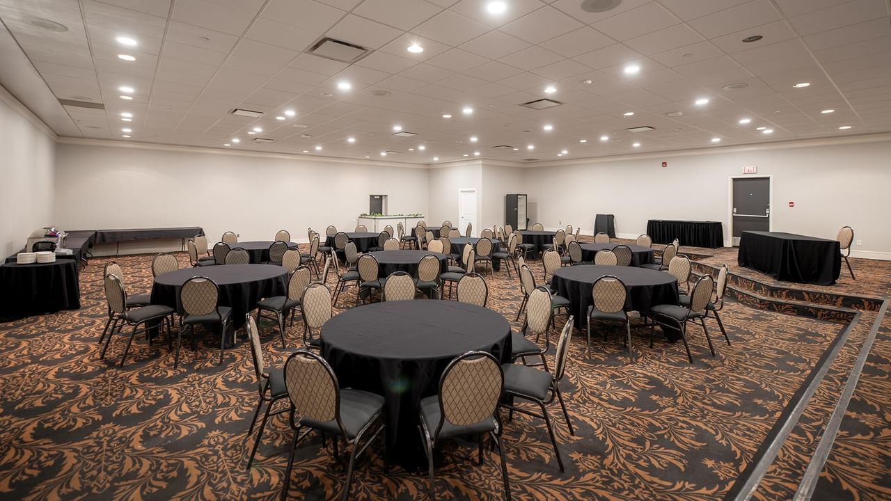 Large conference room with round tables and chairs at Coast Nisku Inn & Conference Centre.