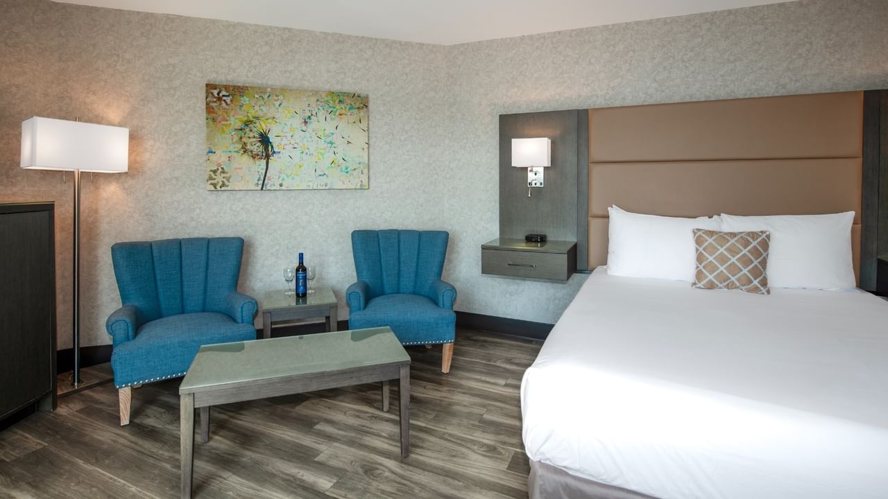 Coast Premium King bed with two blue armchairs