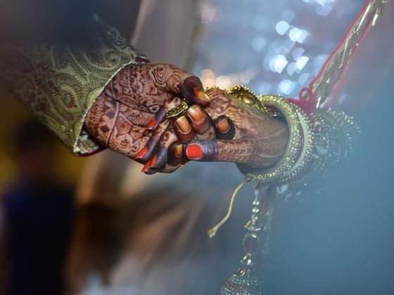 A Malay wedding couple holding hands at Federal Hotels