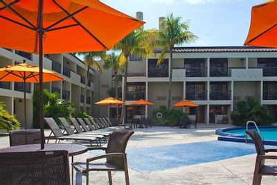 tables and lounge chairs near pool