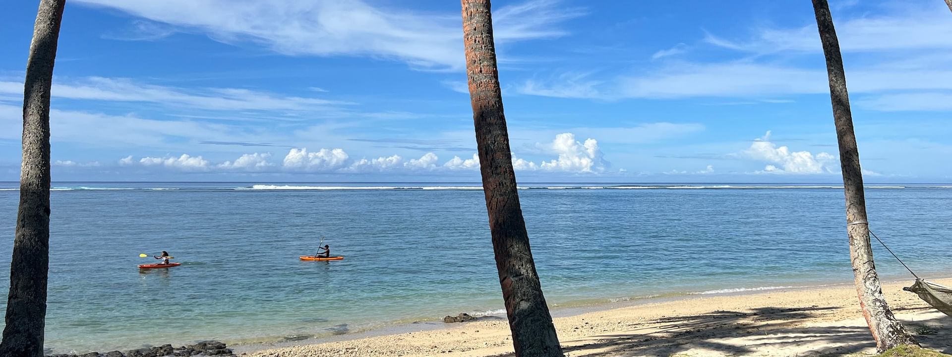 Two kayakers enjoying the private beach view at Tambua Sands Beach Resort in Sigatoka