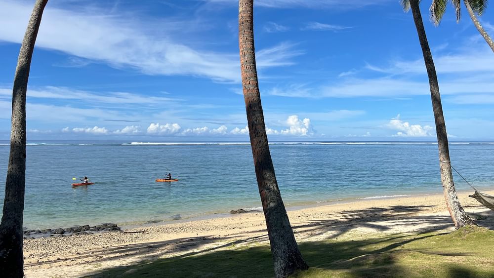 Two kayakers enjoying the private beach view at Tambua Sands Beach Resort in Sigatoka.