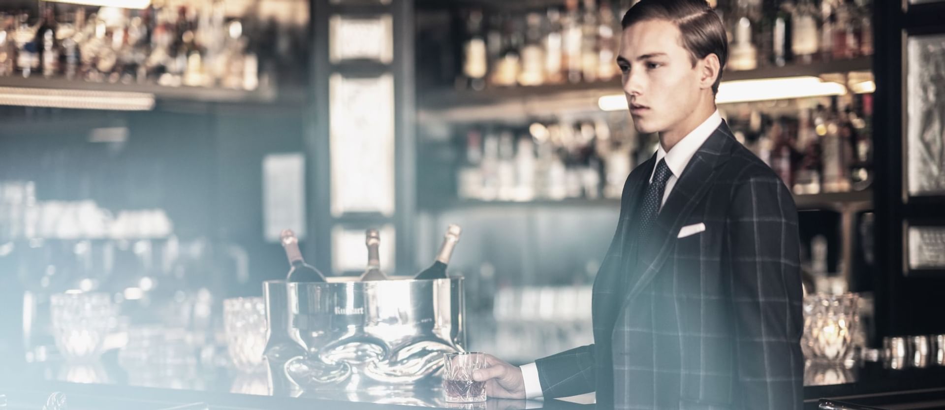 A guy with a drink in the Bar at Patrick Hellman Schlosshotel