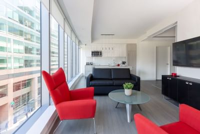 Open kitchen & living room with a television at ReStays Ottawa