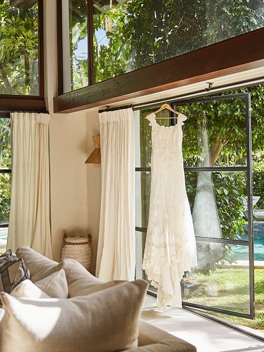 A wedding dress hanging on a hanger in a room at Marbella Club