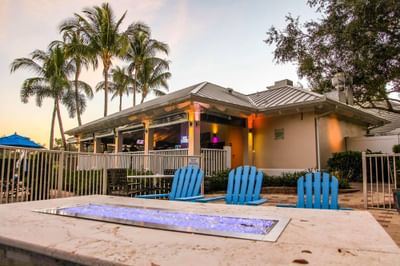 Lounges by a table with a fire place at Trianon Bonita Bay