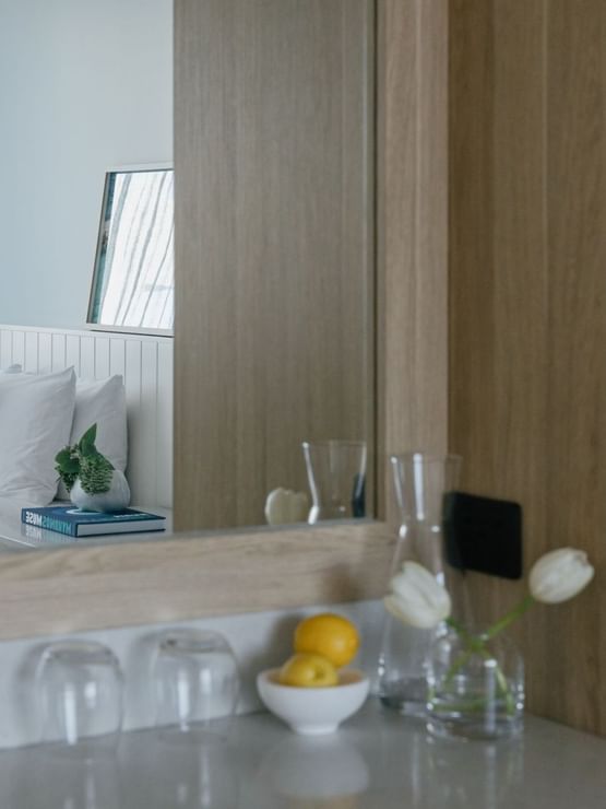 Village Twin reflected in a mirror at Elysium Manly, showing a bed with pillows & a nightstand, best places to stay in Manly