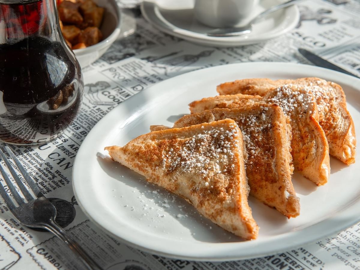 Plate of french toast with maple syrup.