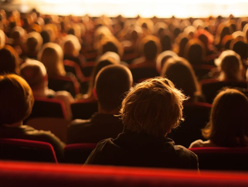 A gathering of people at a theatre 