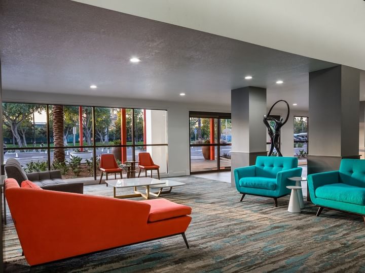 A hotel lobby with modern furniture and large windows