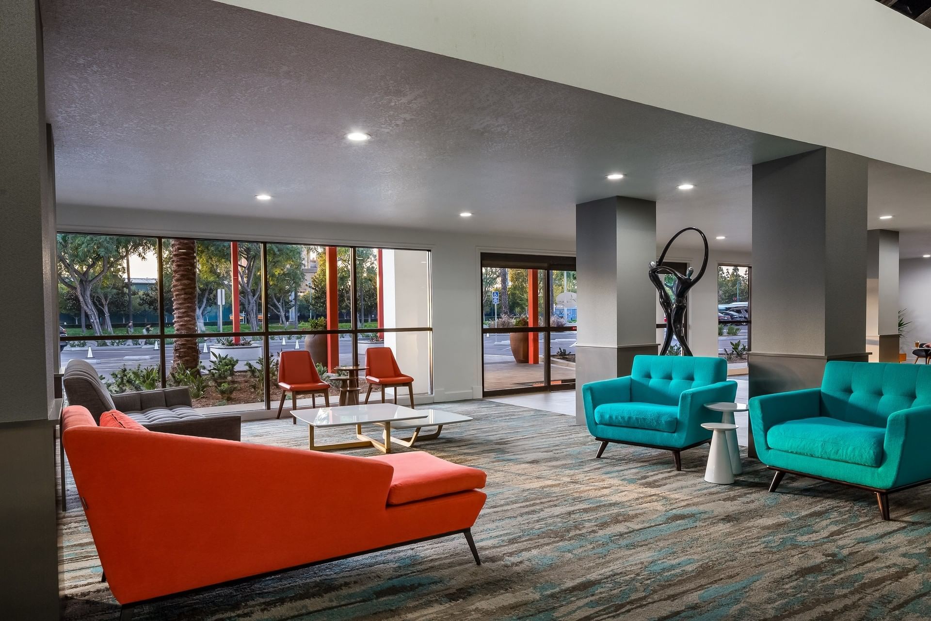 A hotel lobby with modern furniture and large windows