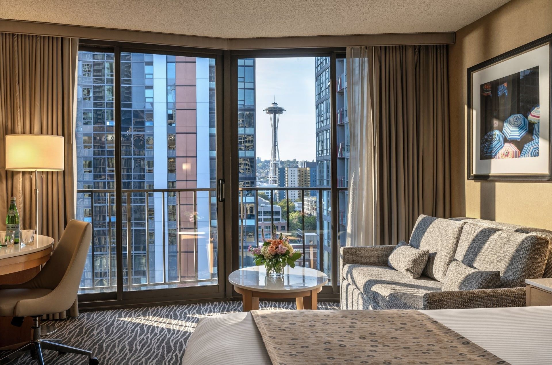 Premier Room features Grey sofa by a marble coffee table under a city view window at Warwick Seattle