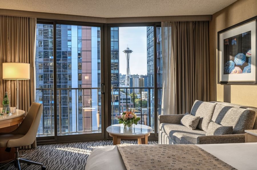 Premier Room features Grey sofa by a marble coffee table under a city view window at Warwick Seattle