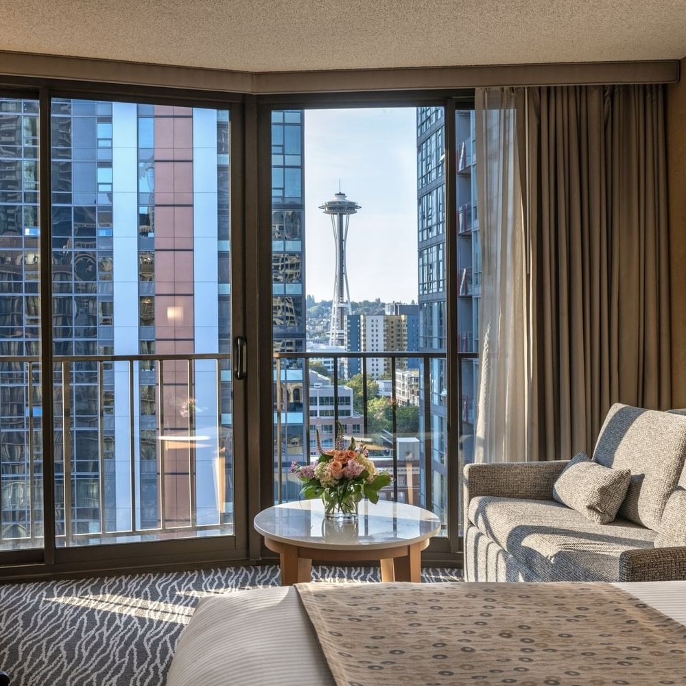 Premier Room features Grey sofa by a marble coffee table under a city view window at Warwick Seattle
