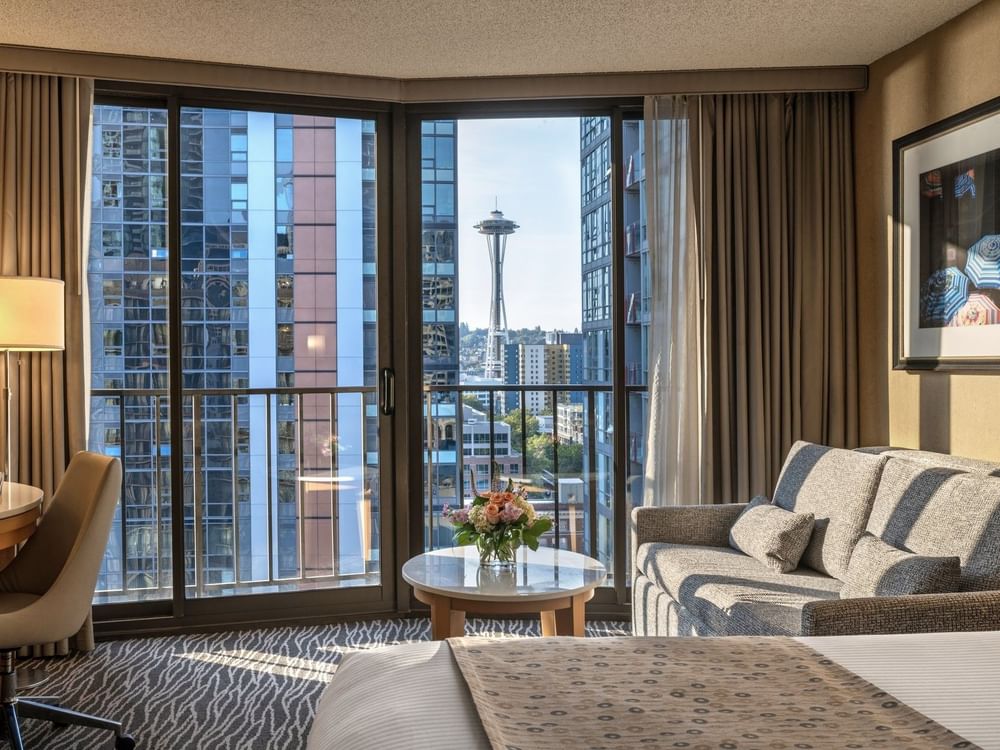 Premier Room features Grey sofa by a marble coffee table under a city view window at Warwick Seattle