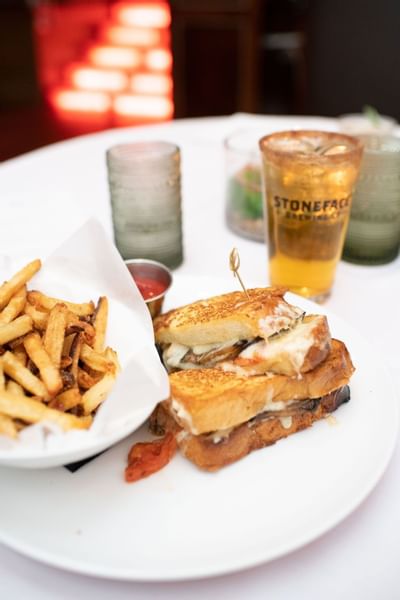 Grilled cheese sandwich, a side of french fries, and a beer on a table at a restaurant at The Exeter Inn