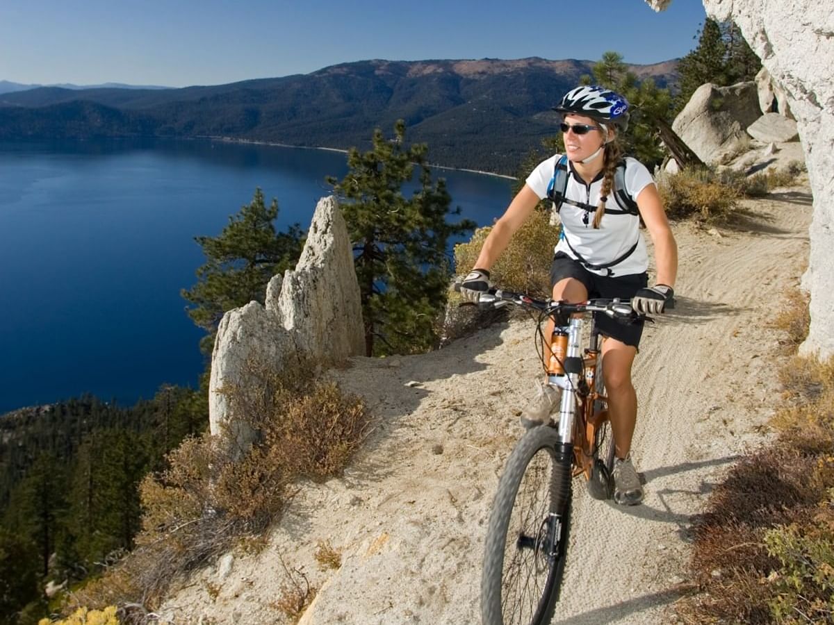 woman biking on flume trail at lake tahoe