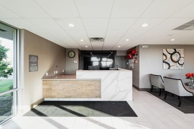Modern front desk and lounge area at Garden Executive Hotel, one of the top-rated South Plainfield hotels
