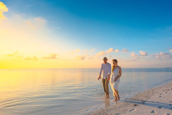 Couple walking in the beach near Thunderbird Beach Resort