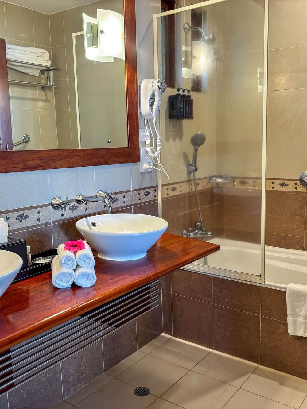 Bathroom with two sinks, bathtub, and shower at The Naviti Resort in Korolevu.