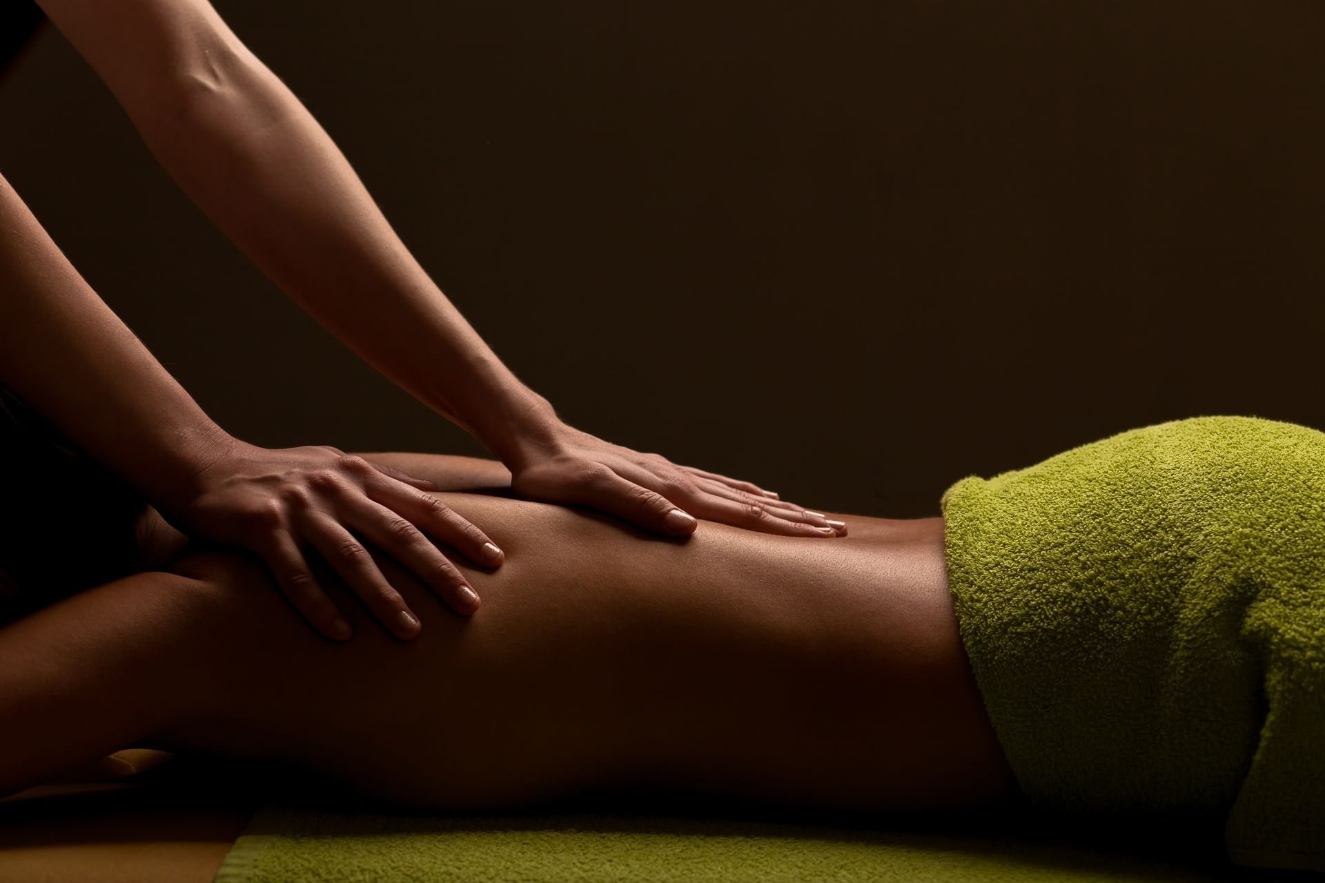 Close-up of a person lying down on a massage table for a relaxing back massage in the spa at El Conquistador Resort