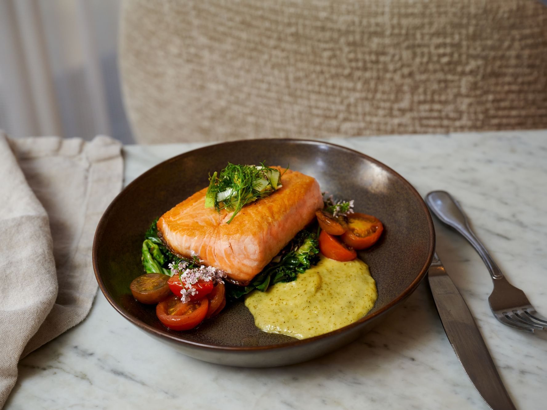 Close-up of Salmon dish served with veg toppings in restaurants on  at Luxe Sunset Blvd Hotel