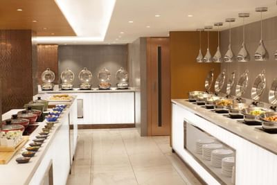 The buffet in Park café at Park Hotel Hong Kong features a bountiful display of freshly prepared dishes & desserts