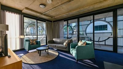 Living area with cozy loungers in a room at Nesuto Hotels