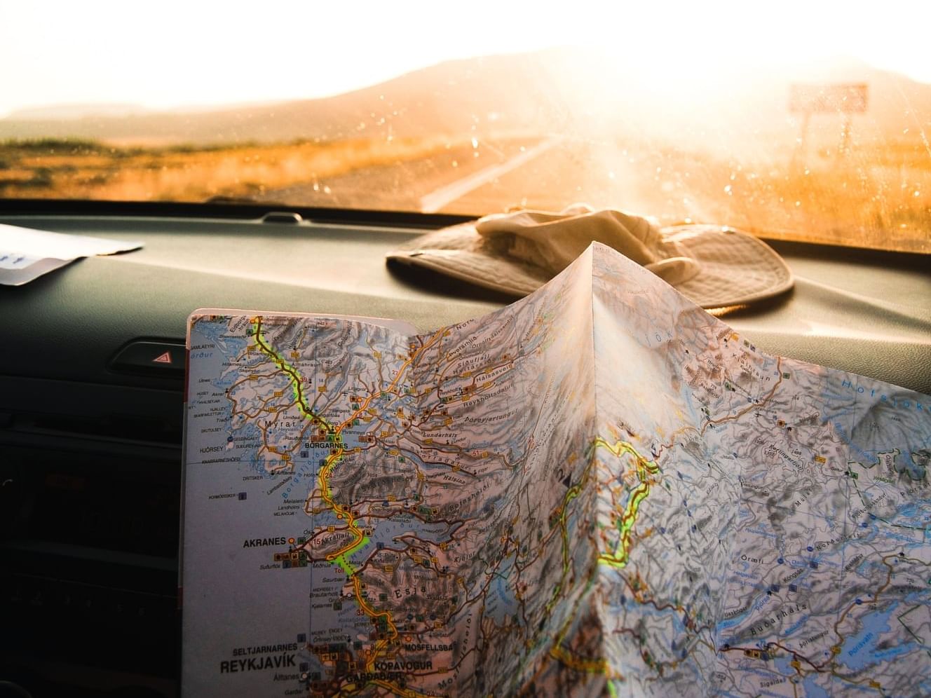 A map on top of a dashboard of a car near Henn Na Hotel