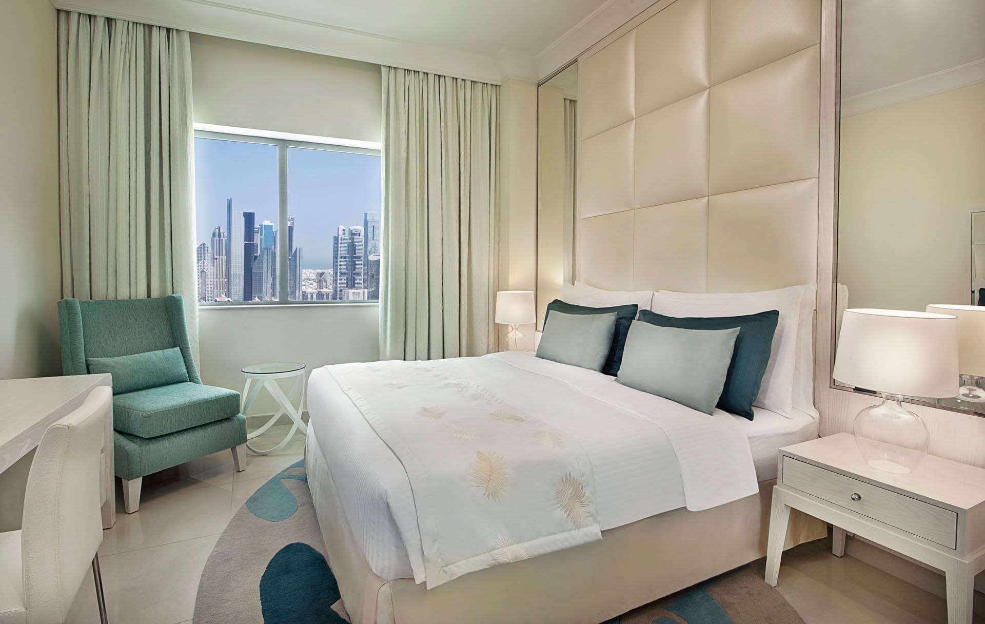 Bed with nightstands and city view in One Bedroom Suite at DAMAC Maison Mall Street