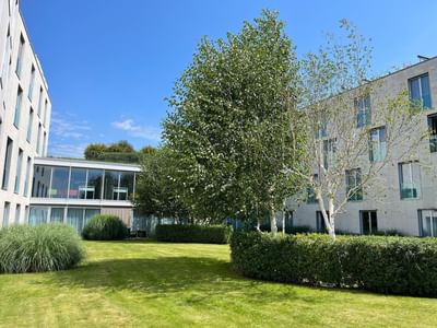 Exterior view of the hotel & garden area on a sunny day at Starling Hotels Lausanne Switzerland