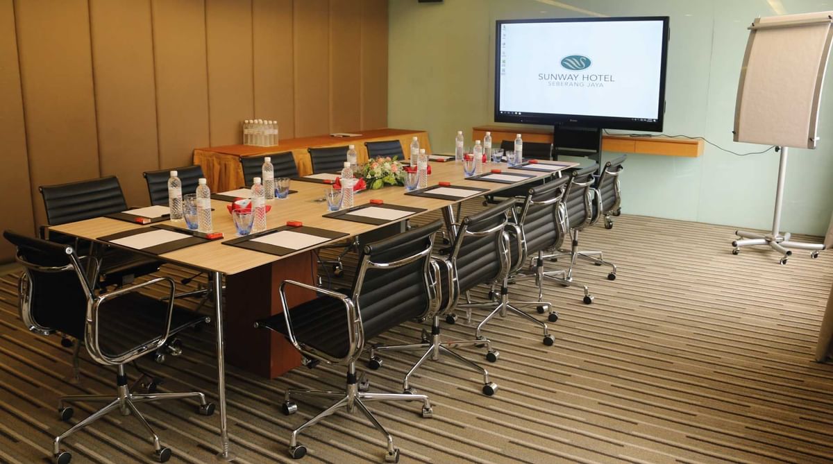 Boardroom meeting room arranged with a TV and chairs at Sunway Hotel Seberang Jaya