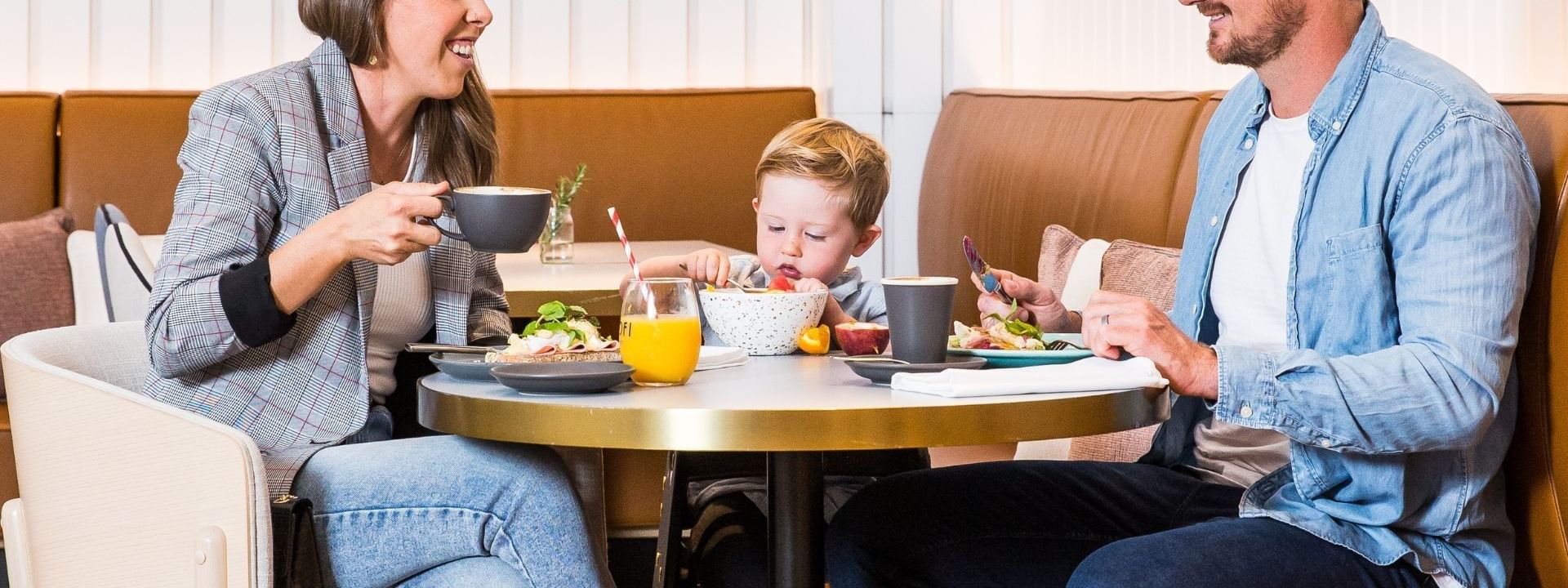 Family enjoying a buffet breakfast together at a table, showcasing the Stay Sip & Savour package.