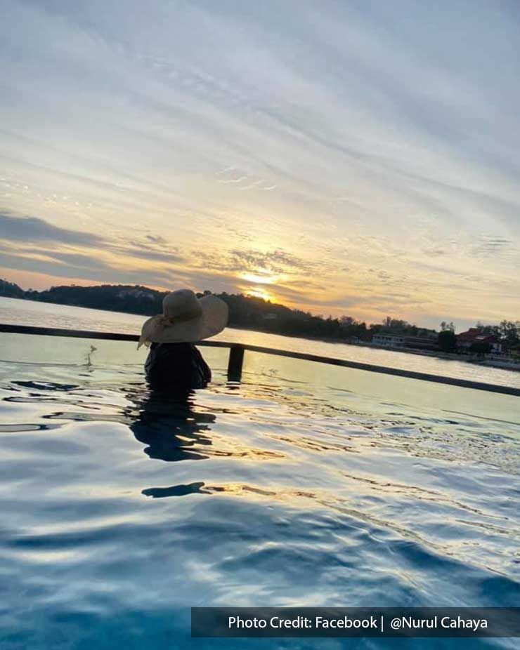 A woman enjoying her private pool at Lexis Hibiscus Resort