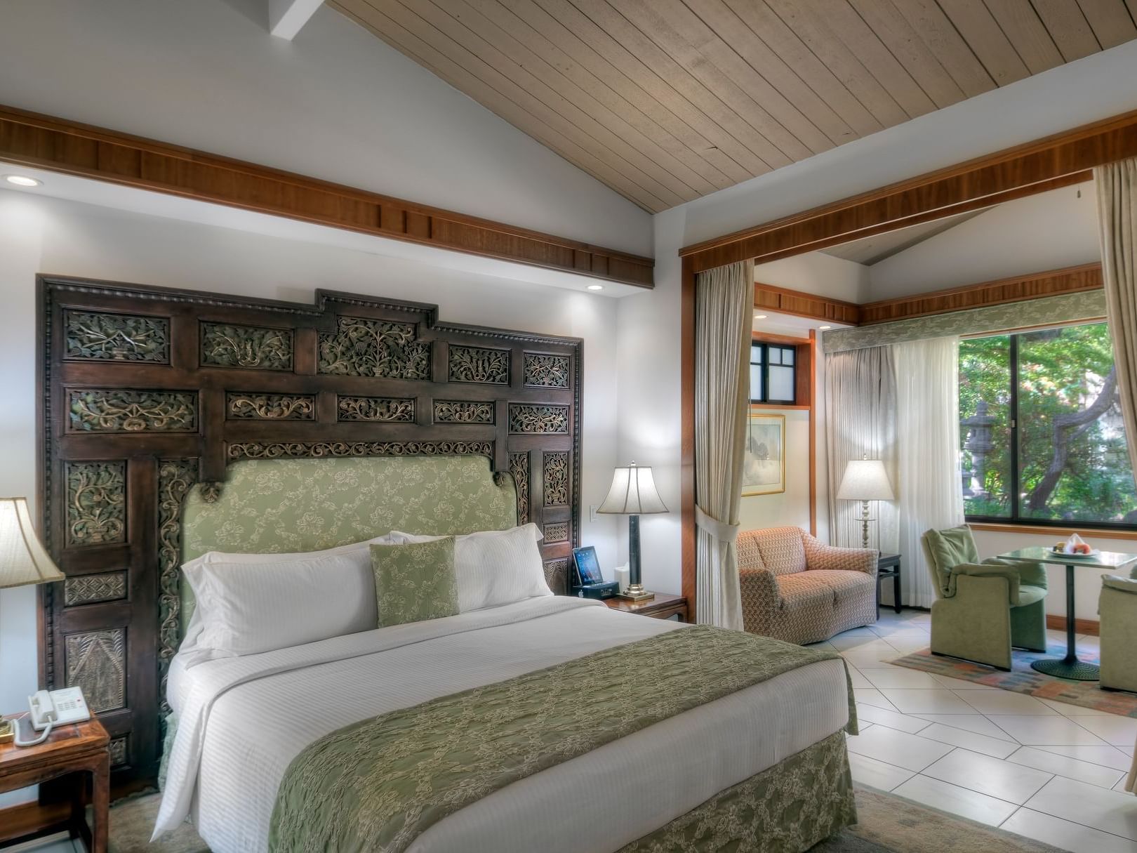 bedroom with white sheets and green decoration