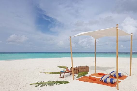 A beach setting with a canopy and two chairs near Grand Park Kodhipparu, Maldives