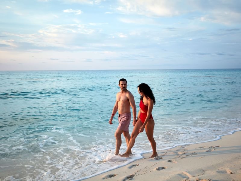 Couple walking on the beach near Fiesta Americana