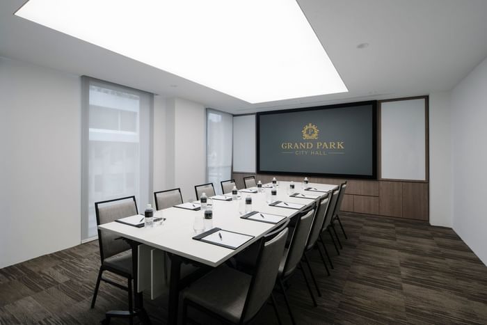 Boardroom set-up in a meeting room with wooden floors at Grand Park City Hall