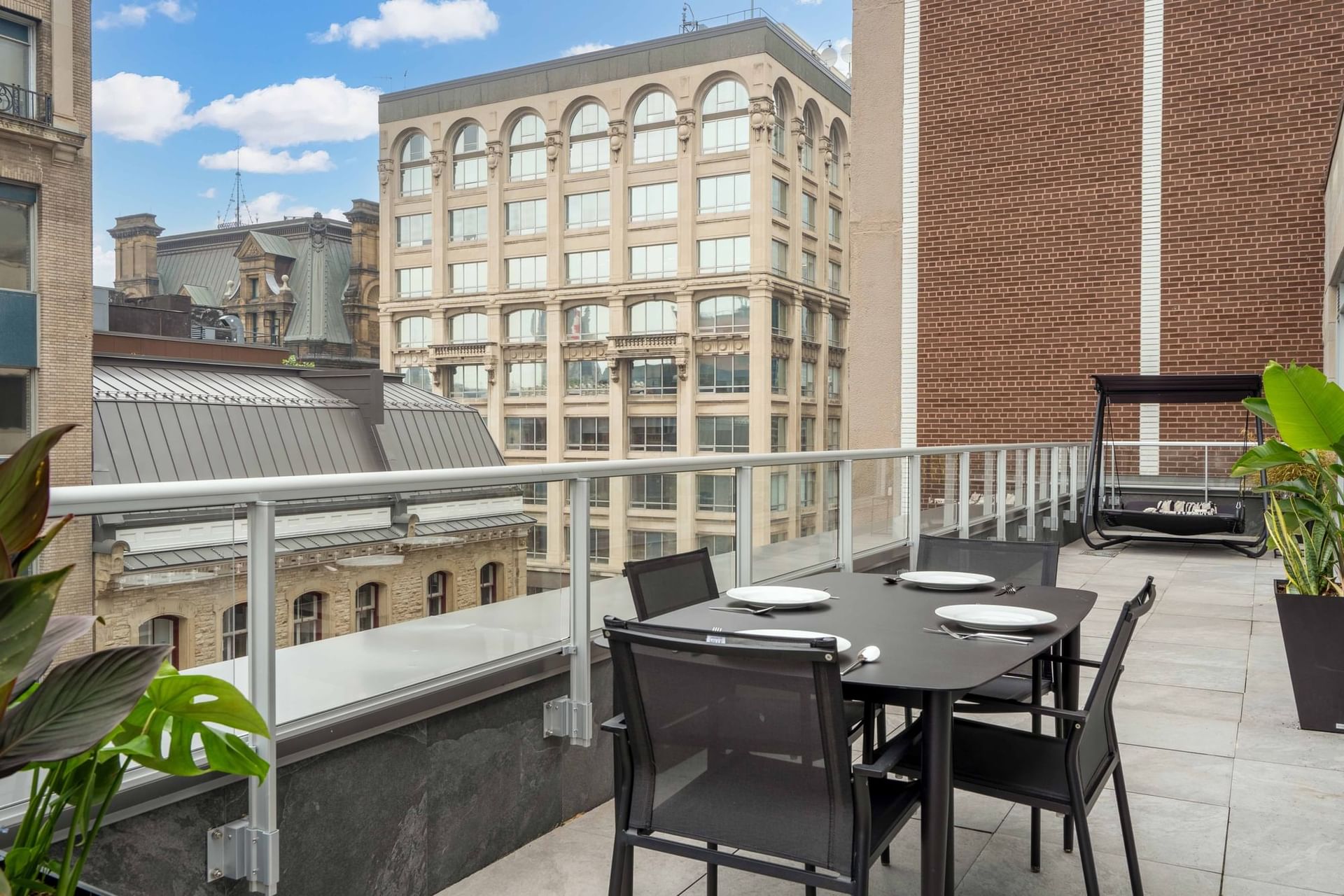 Balcony dining area with city view in Penthouse Suites at ReStays Ottawa