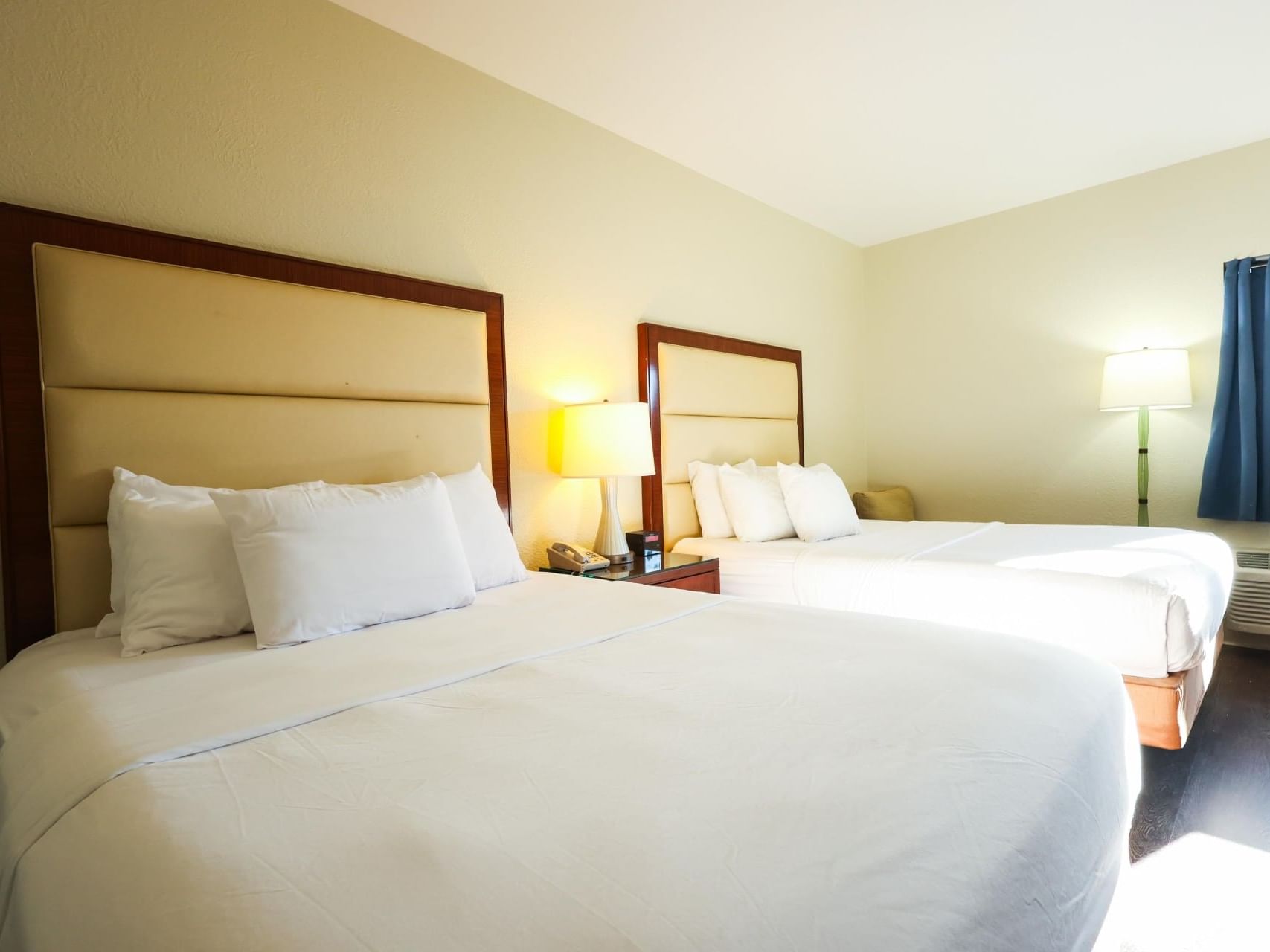 Two cozy beds with nightstand in Standard Queen Room at South Branch Inn Moorefield