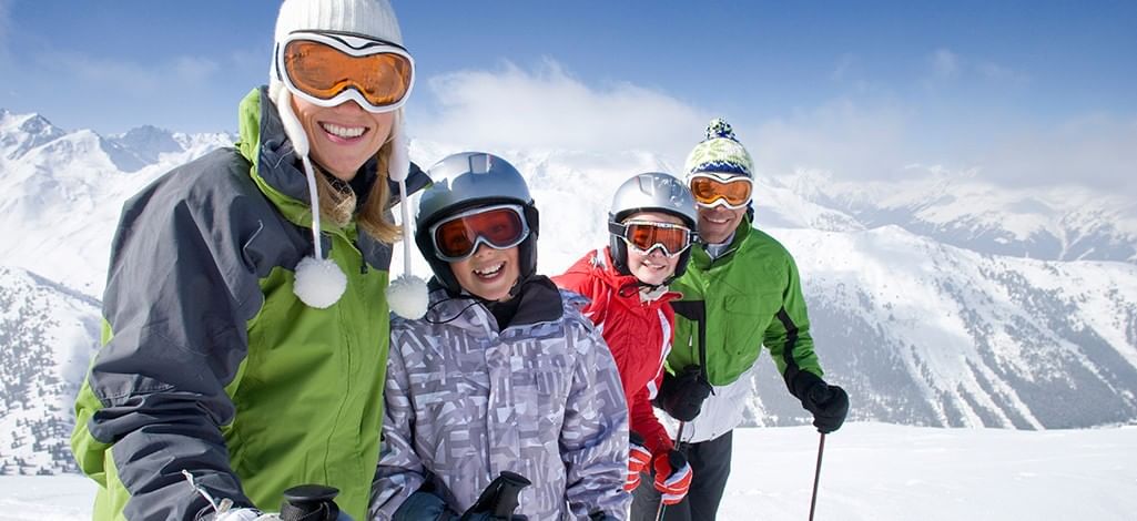 a family of four skiing happily