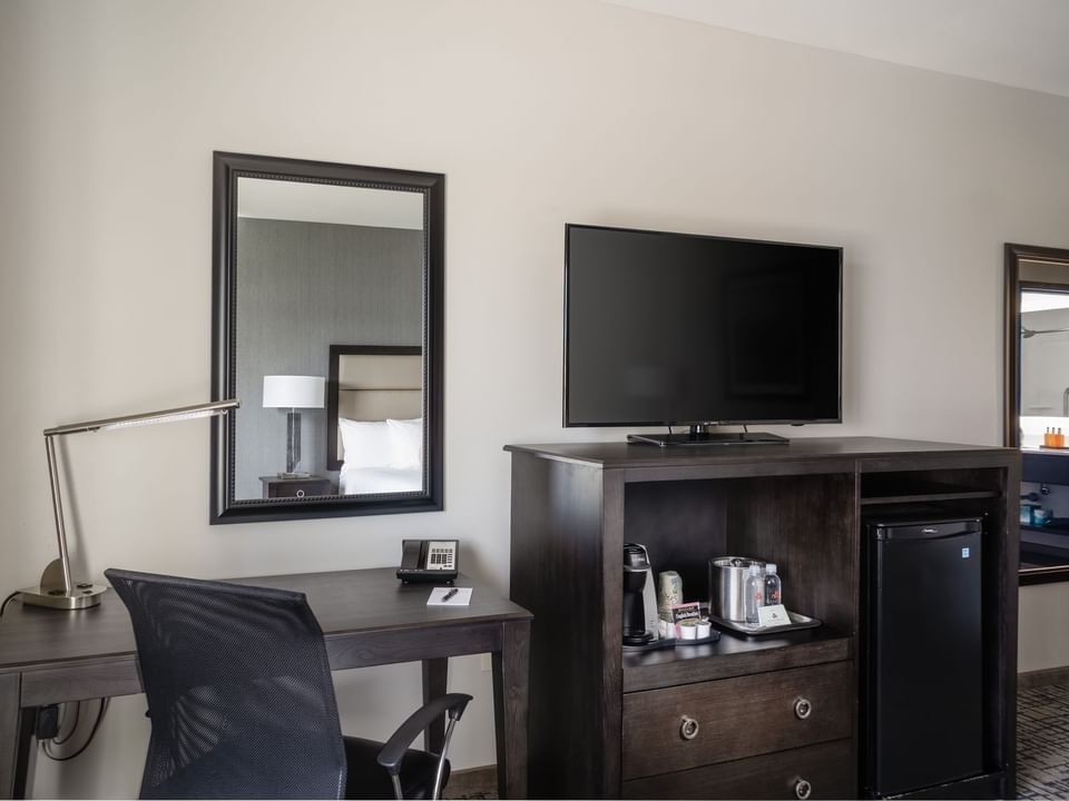 Workspace with TV stand and coffee maker in the King Room at Shangri-La Resort and Golf Club