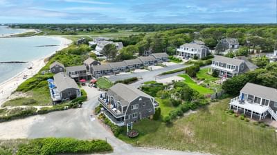 Aerial view of the hotel complex, driveway & beach near Chatham Tides Resort