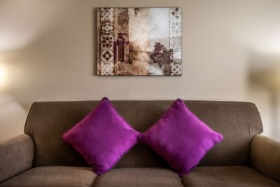 Purple pillows on a couch at Grand Legacy at The Park Anaheim.
